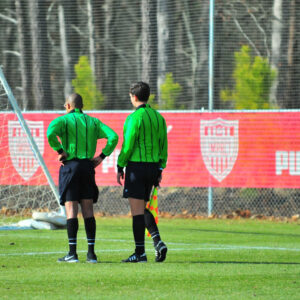 SOCCER FIELD WITH RED BANNER ON A FENCE