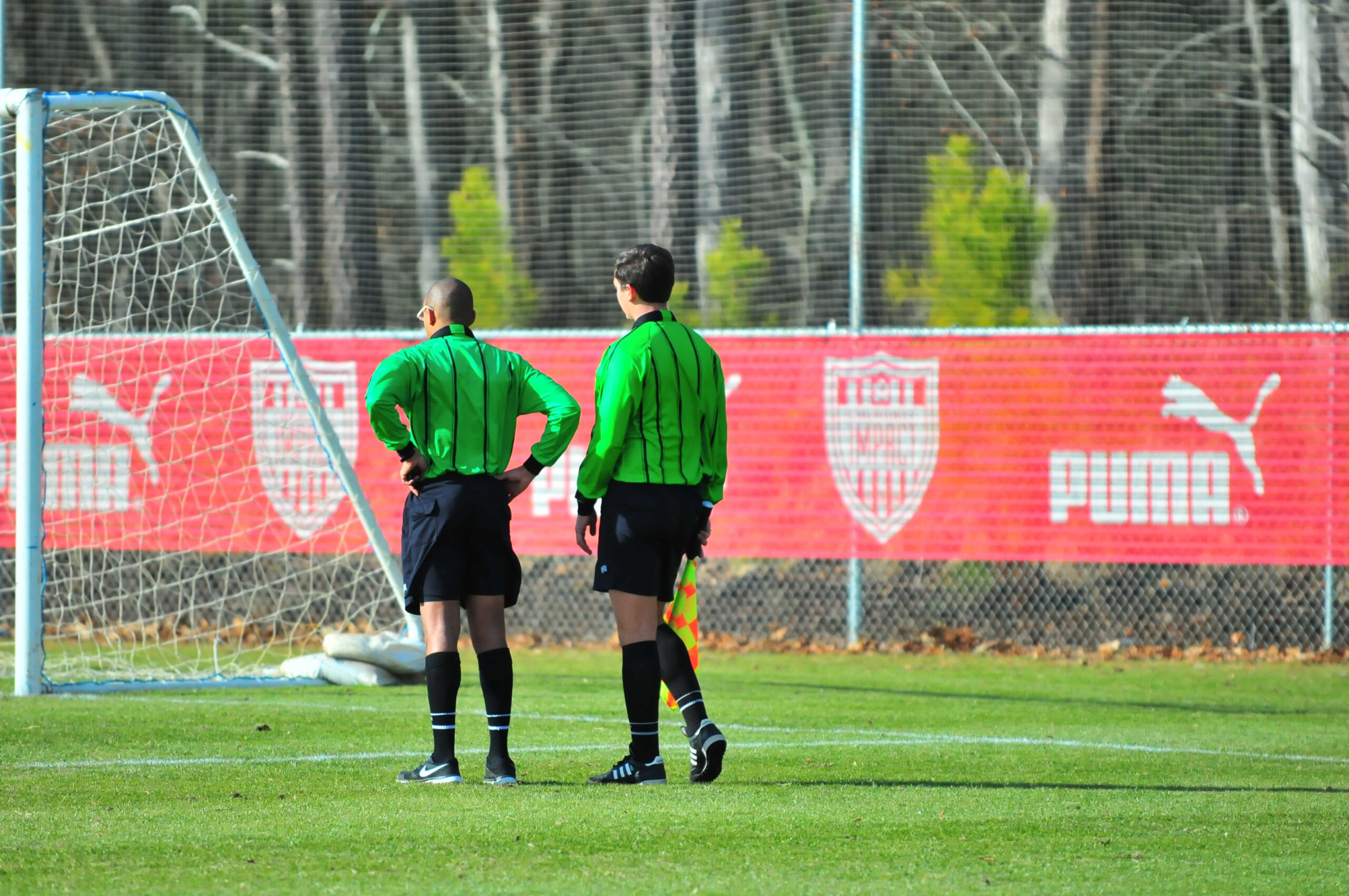 SOCCER FIELD WITH RED BANNER ON A FENCE