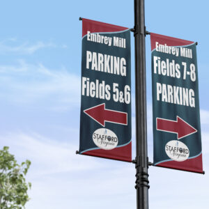 banners on a pole showing the direction of sports field